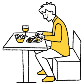 ナイフとフォークで食事をする男性のテーブルを真横から見たアングル